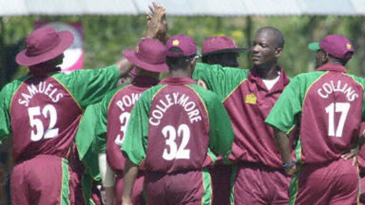 Darryl Brown celebrates with teammates the dismissal of Zimbabwe batsman Andy Flower