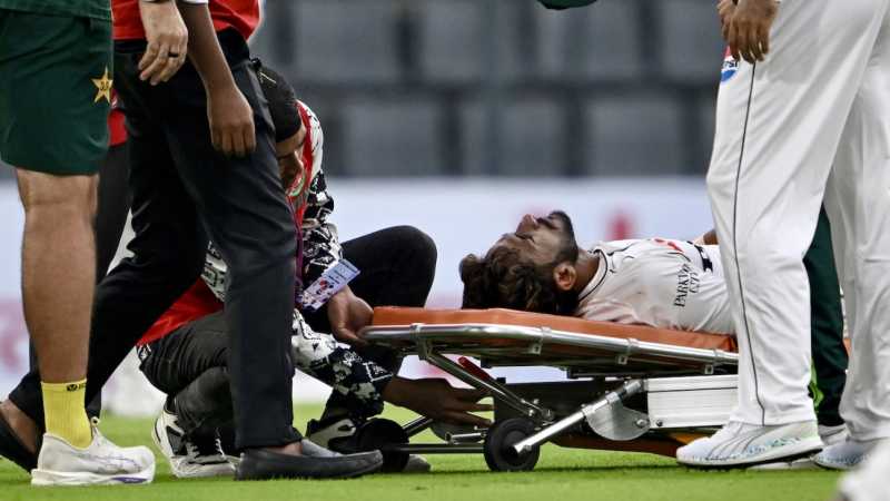 Medical staff assisting Hasan Ali on the field