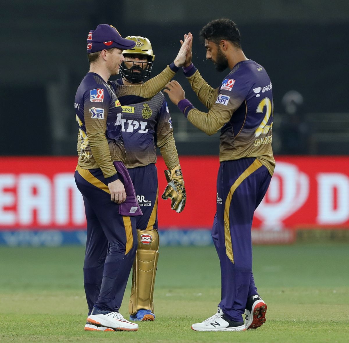 Eoin Morgan, Dinesh Karthik and Varun Chakravarthy celebrate the fall of Mayank Agarwal, Kolkata Knight Riders vs Punjab Kings, IPL 2021, Dubai, October 1, 2021