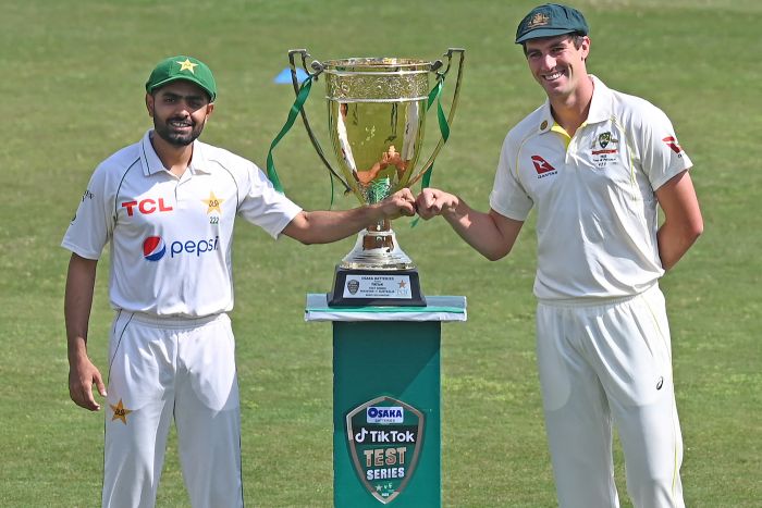 Babar Azam and Pat Cummins pose together in front of the Benaud-Qadir Trophy | ESPNcricinfo.com