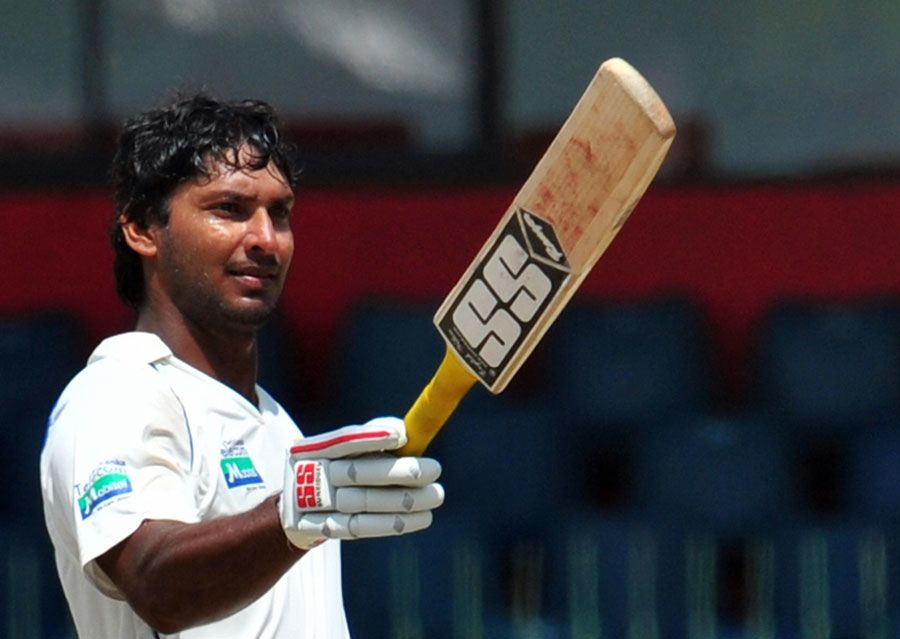 Kumar Sangakkara raises the bat after reaching his century ...