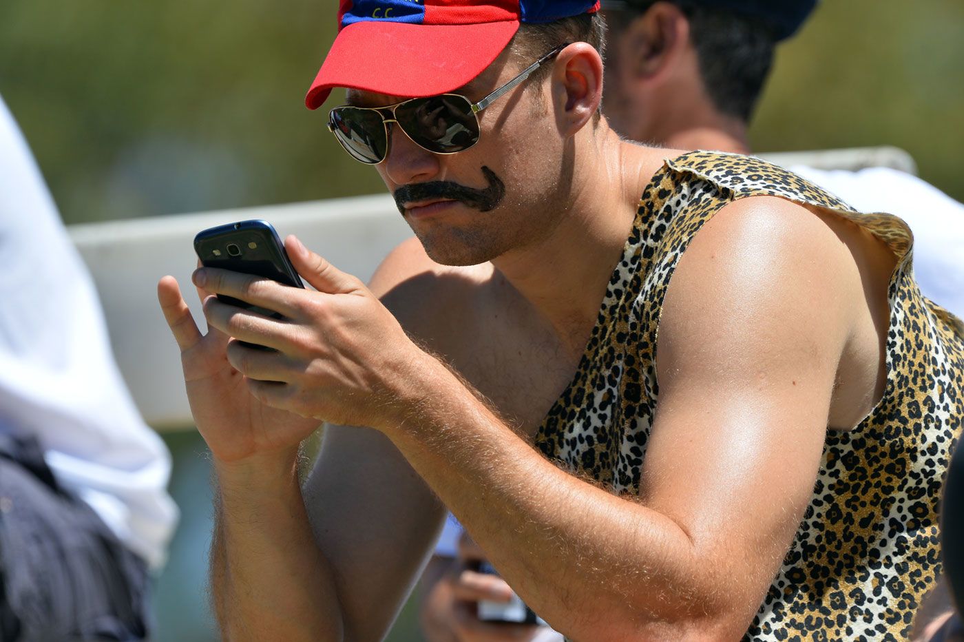 A fan looks at his phone