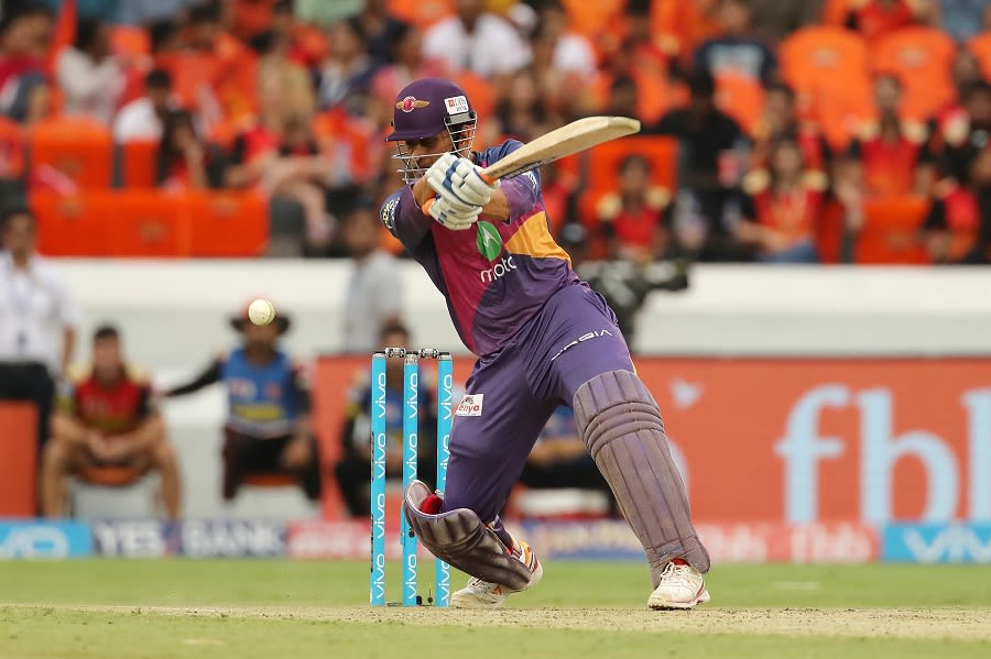 MS Dhoni clears his front foot and launches into a shot | ESPNcricinfo.com