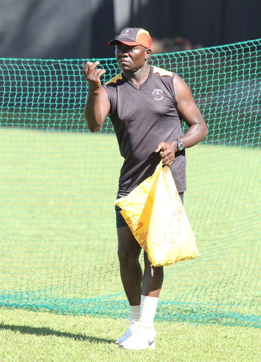 Uganda Coach Steve Tikolo Helps A Batsman Practice The Sweep With Some
