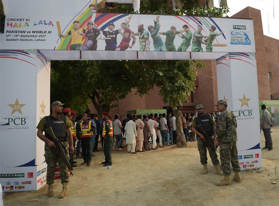 Army soldiers stand guard at the entrance of the venue as spectators ...