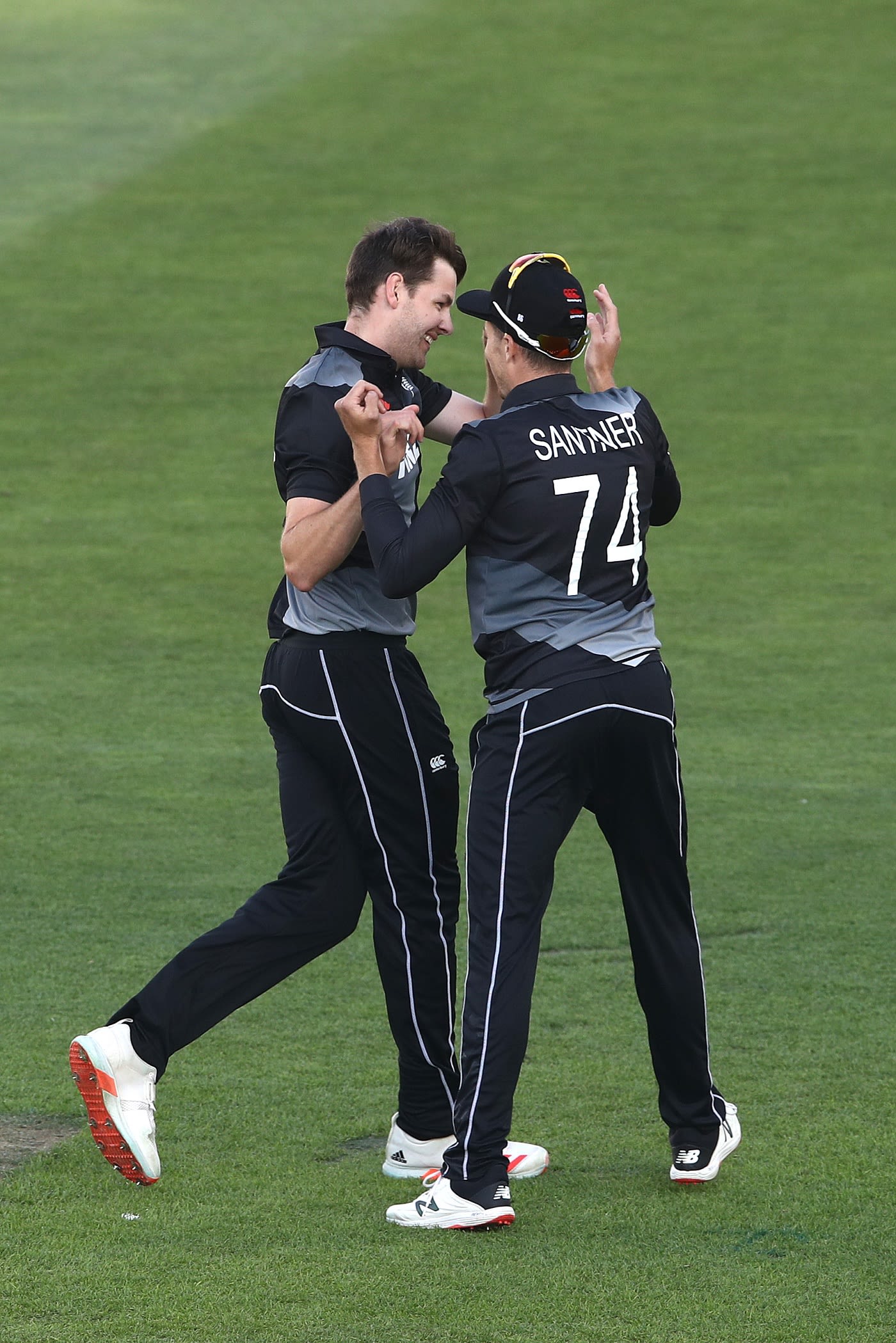 Jacob Duffy celebrates a wicket with his captain Mitchell Santner