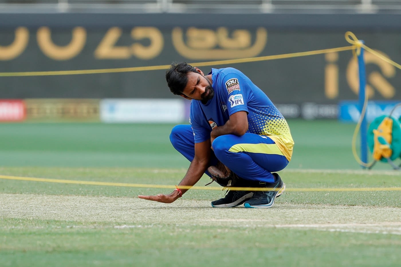 Chennai Super Kings bowling coach L Balaji examines the Dubai pitch