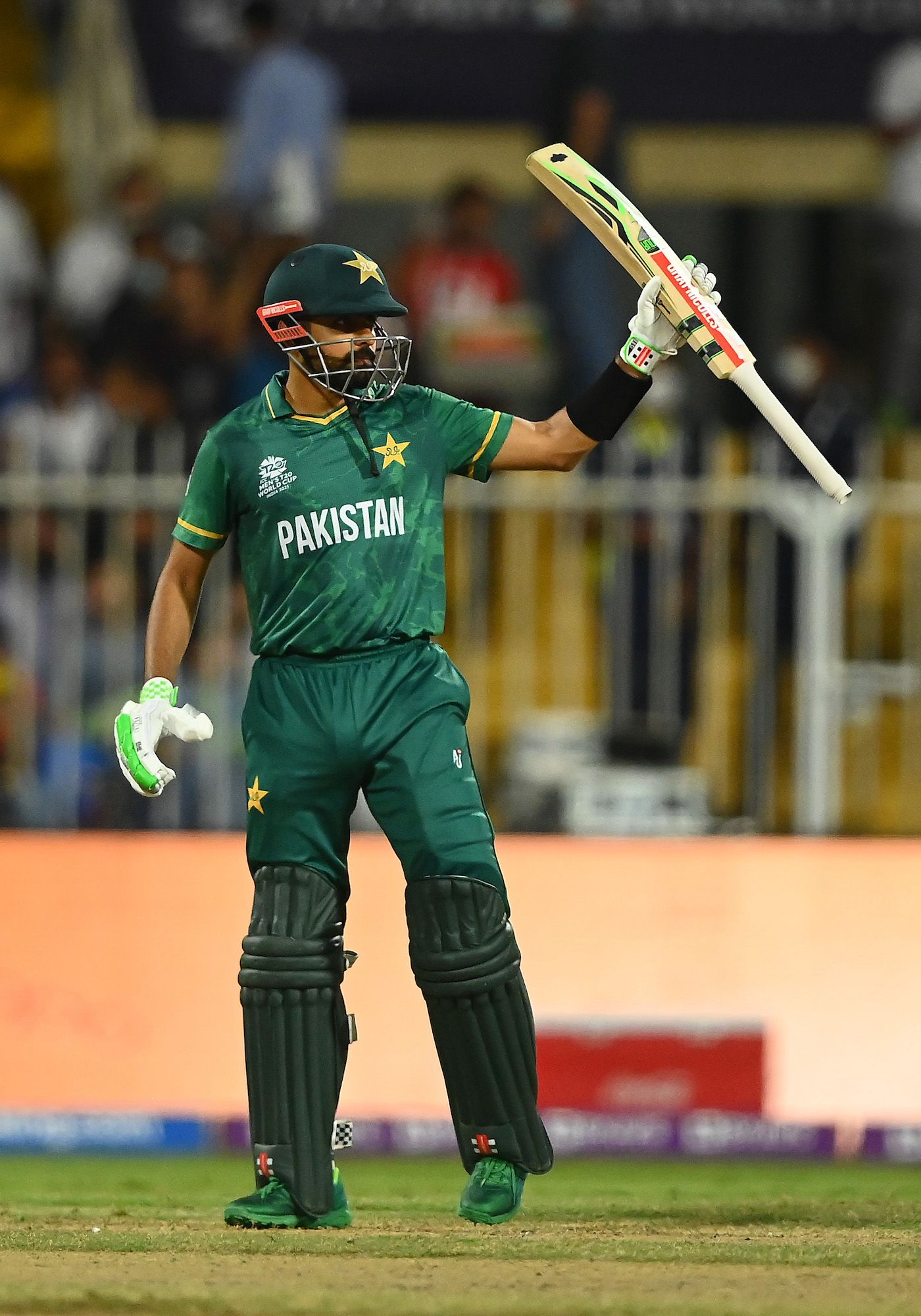 Babar Azam raises his bat after getting to a half-century ...