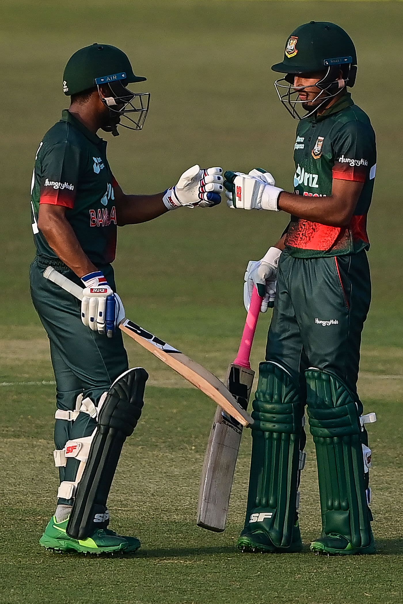 Afif Hossain (R) bumps fists with Mehidy Hasan Miraz during their Afif Hossain (R) bumps fists with Mehidy Hasan Miraz during their