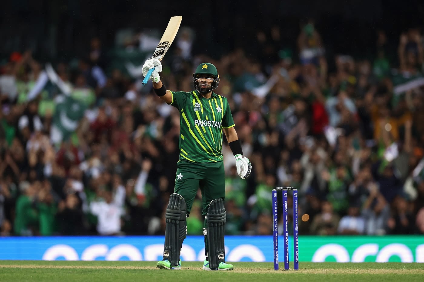 Iftikhar Ahmed raises his bat after scoring an important half-century ...