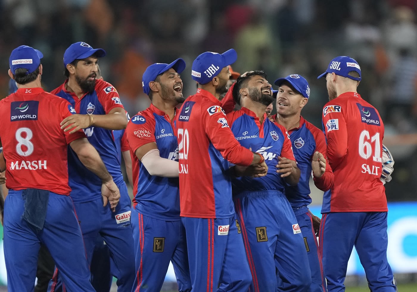 An elated Mukesh Kumar is mobbed by team-mates after he defended 12 ...