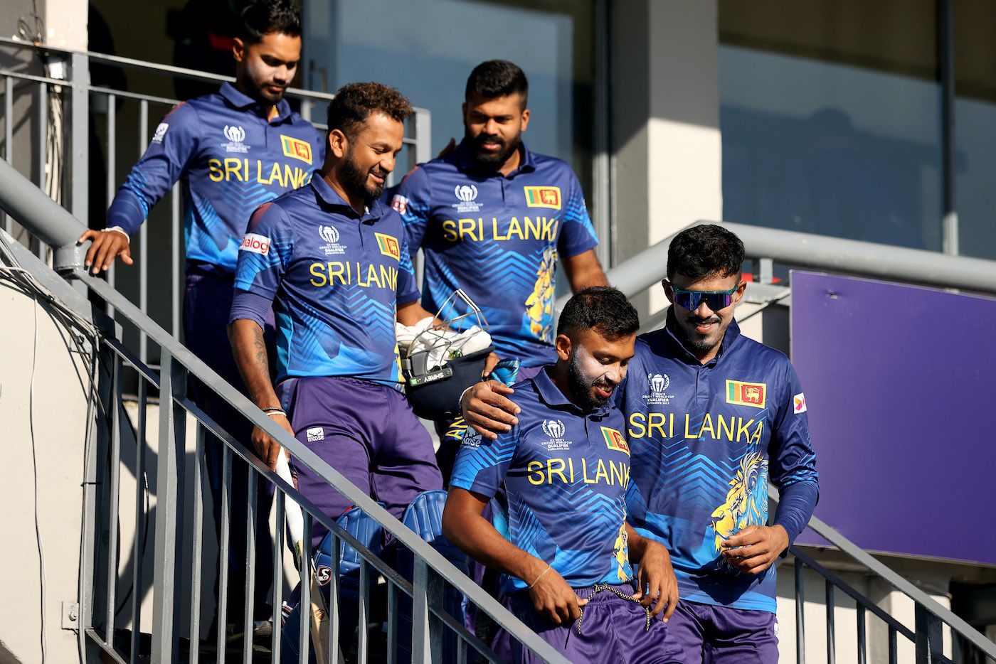 Sri Lankan players gel along as they walk down the stairs