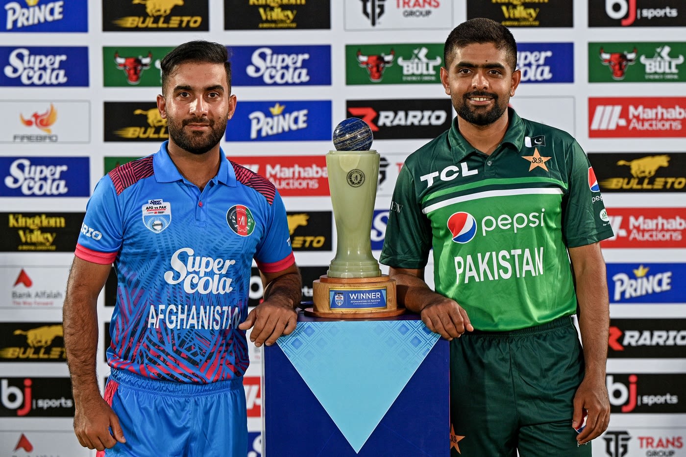 Hashmatullah Shahidi and Babar Azam pose with the trophy as the two ...