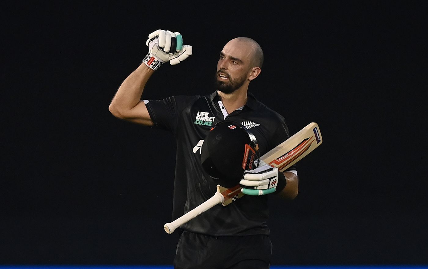 Daryl Mitchell celebrates his fourth ODI century