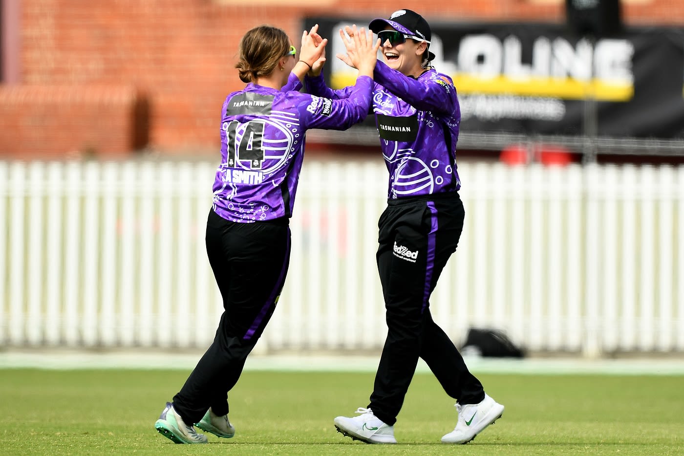 Heather Graham and Amy Smith celebrate the fall of a wicket ...