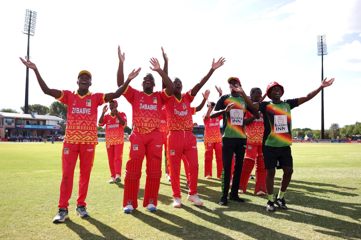 The Zimbabwe players celebrate in front of their supporters