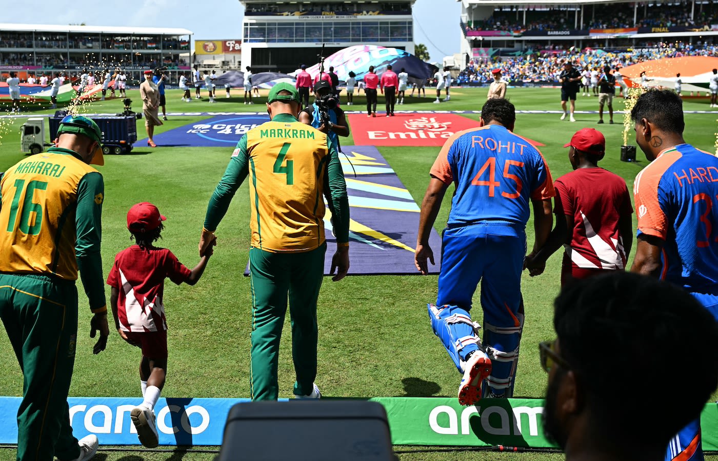 The teams and their mascots walk out for the national anthems ...