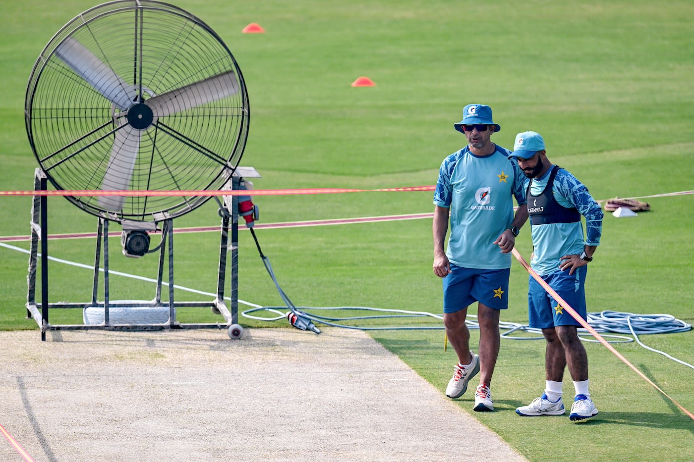 Azhar Rwp Azhar Mahmood and Sajid Khan take stock as a giant fan does its work on ...