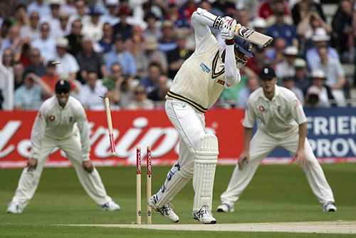 Stumps flying Michael Vandort is bowled by Jon Lewis