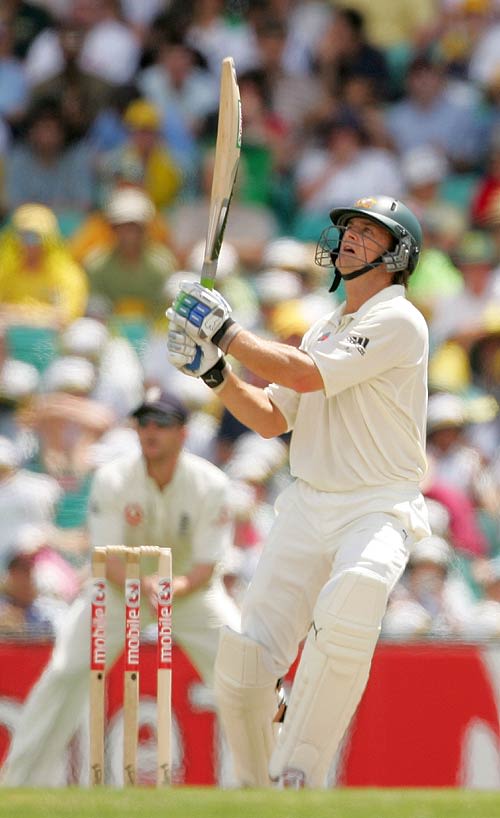 Adam Gilchrist sends a ball high during his firstinnings 62