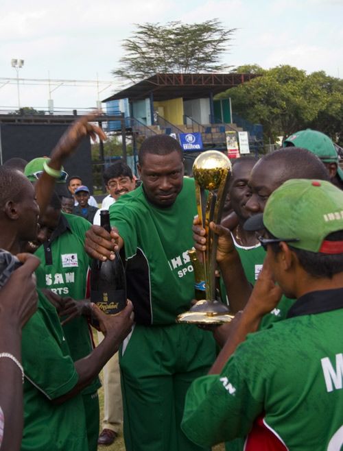 Roger Harper, the Kenya coach, samples the champagne