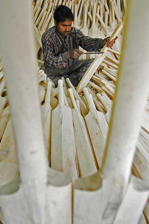 An Indian batmaker works on his latest creation