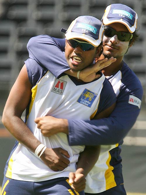 Malinga Bandara and Kumar Sangakkara share a light moment during a ...