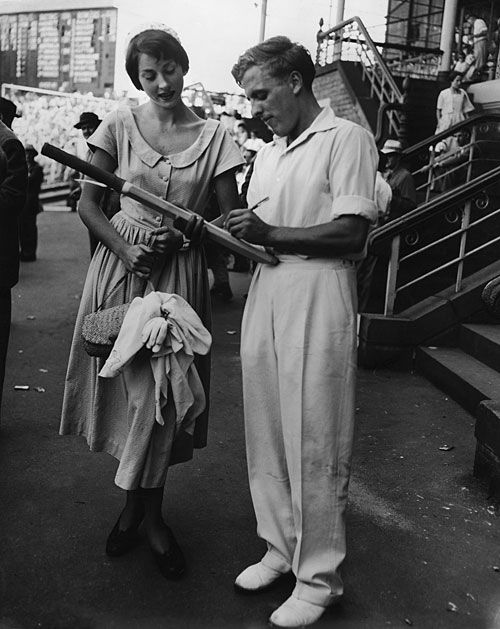 Bob Berry signs a bat for a fan